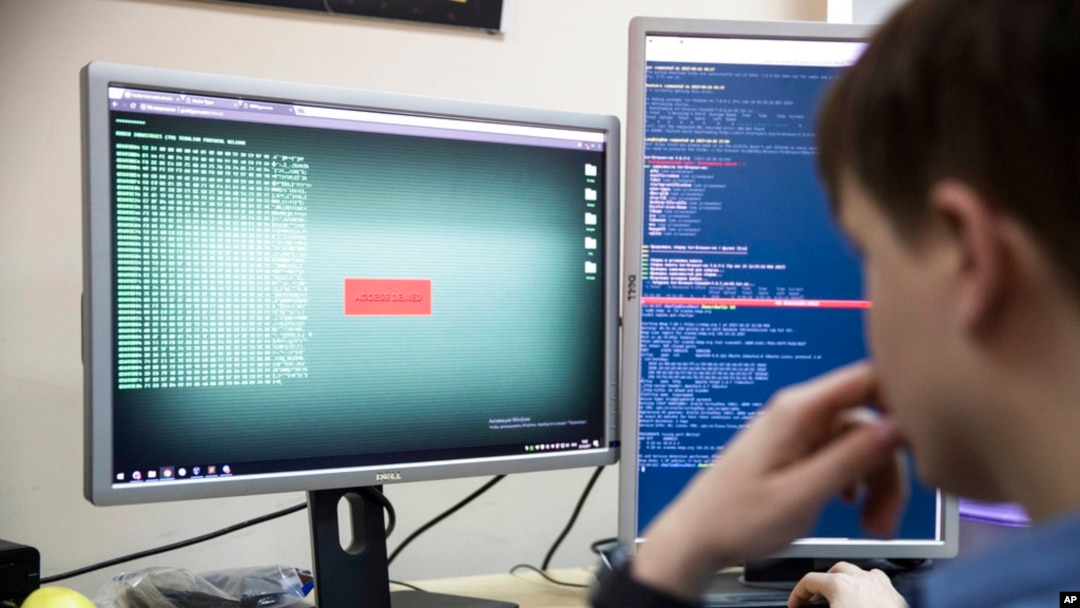 FILE - A cybersecurity worker develops computer code in an office in Moscow, Russia, Oct. 25, 2017. The U.S. and allies are bracing for the possibility that a Russian invasion of Ukraine would have a ripple effect in cyberspace.