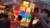FILE - In this Jan, 23, 2020, photo released by Initium Media, tourists take photographs outside the Casino Lisboa in Macao.