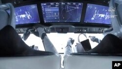 In this image from video made available by NASA, astronauts in the SpaceX Dragon capsule approach the International Space Station, Nov. 11, 2021. 