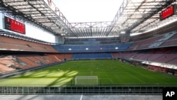 FILE - In this March 8, 2020, photo, a view of the empty San Siro stadium during the Serie A soccer match between AC Milan and Genoa, in Milan, Italy. 
