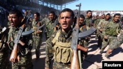 FILE - Syrian Democratic Forces celebrate the first anniversary of Raqqa province liberation from the Islamic State group in Raqqa, Syria, Oct. 27, 2018.