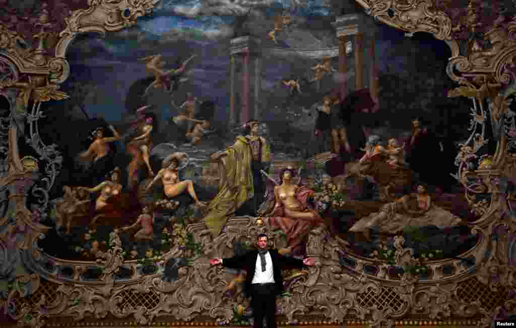 Czech painter and scenic designer Martin Cerny stands in front of a newly installed curtain during a general renovation of Prague's State Opera building in Prague, Czech Republic.