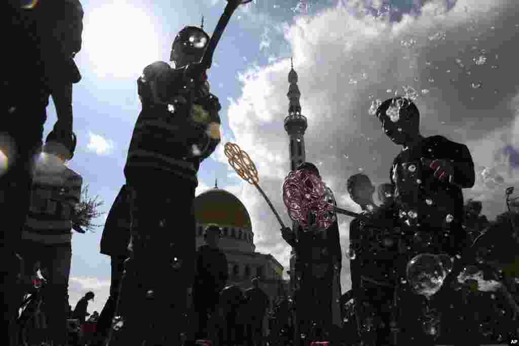 Israeli Arab kids play with soap bubbles during a protest against U.S. President Donald Trump's Mideast initiative, in the Israeli Arab town of Jaljulia, Israel.