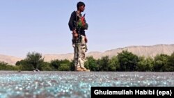 FILE - An Afghan soldier keeps watch during clashes with Islamic State (IS) militants in Kot district of Nangarhar province, Afghanistan, June 26, 2016. 