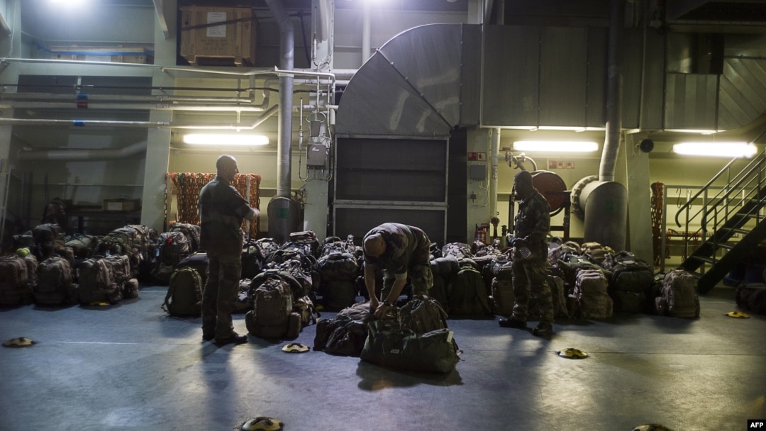 French military packing their bag aboard the French Navy amphibious assault ship BPC Dixmude moored in the port of Douala, Dec. 3, 2013.