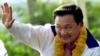 FILE - Thai telecommunication tycoon and leader of Thai Rak Thai Party Thaksin Shinawatra waves during campaign rally in Bangkok, Dec. 26, 2000. The controversial former Prime Minister of Thailand, returned to Thailand last year after nearly a decade of self-imposed exile. 