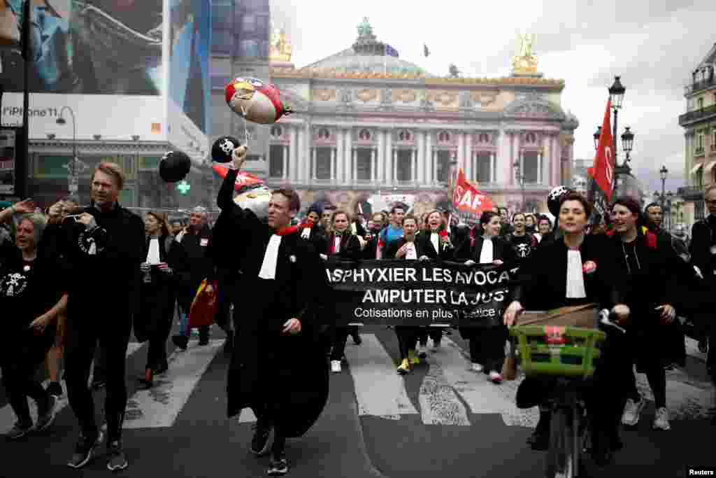 French lawyers on strike take part in a protest against the government's pension reform bill and justice in front of the Opera Garnier in Paris.