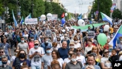 People hold posters that read: "I am, We are Sergei Furgal, Sergei Furgal our Governor", during an unsanctioned protest in support of Sergei Furgal, the governor of the Khabarovsk region, in Khabarovsk, 6100 kilometers east of Moscow, Aug. 8, 2020.