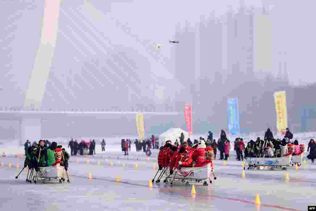 Teams compete during a dragonboat on ice competition in Shenyang in China's northeastern Liaoning province.