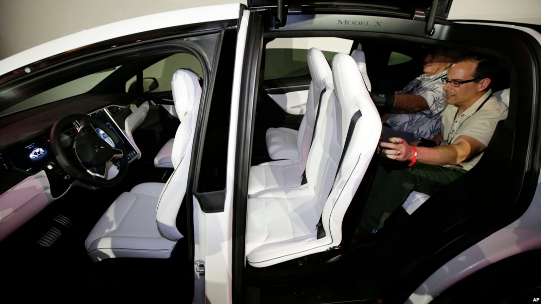 FILE - The Tesla Model X car, with a third row of seats, is introduced at the company's headquarters, Sept. 29, 2015, in Fremont, Calif. 