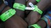 African immigrants, displaced by anti-foreigner violence in Cape Town, show registration bands issued by disaster management officials. (Reuters)