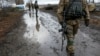 FILE - A Ukrainian serviceman in December passes a checkpoint near the eastern Ukrainian town of Debaltseve, Dec. 24, 2014.
