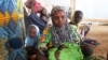 FILE - A family of refugees that fled their homes due to violence from the Islamic extremist group Boko Haram sit inside a refugee camp in Minawao, Cameroon, Feb. 25, 2015.