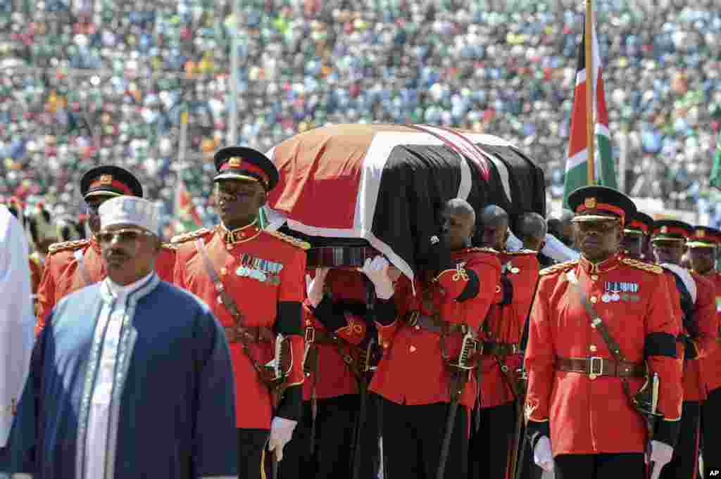 Kenyan military pallbearers carry the casket of former president Daniel arap Moi, draped in a Kenyan flag, at his state funeral in Nyayo Stadium, in Nairobi.