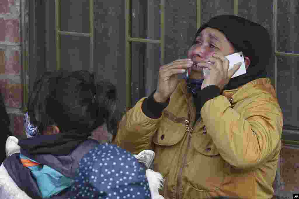 The relative of an inmate cries as she speaks on the phone outside La Modelo jail in Bogota, Colombia. Violence broke out in the prison out of inmates' fears that authorities are not doing enough to prevent coronavirus inside overcrowded prisons.