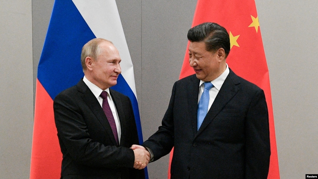 FILE PHOTO: Russian President Putin meets with Chinese President Xi during their meeting on the sideline of the BRICS summit in Brasilia