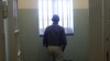 U.S. President Barack Obama stands in the Robben Island prison cell that Nelson Mandela spent 18 of his 27 years of imprisonment near Capetown, June 30, 2013. 