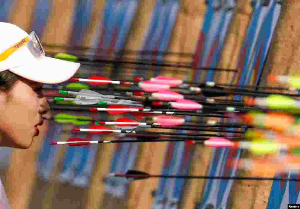 Vietnam’s Le Phuong Thao examines the target during women's individual compound qualification round archery event at the Southeast Asian Games in Clarke, Philippines.