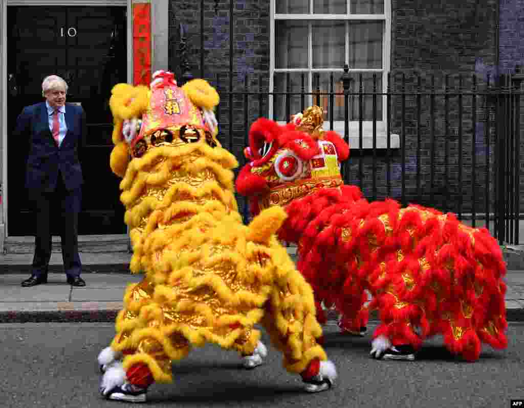 Britain's Prime Minister Boris Johnson reacts as he watches Chinese Lions perform, as he hosts a Chinese New Year reception at 10 Downing Street in central London.