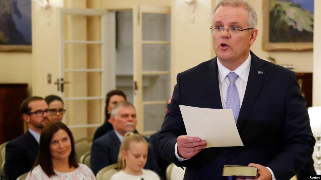 New Australian Prime Minister Scott Morrison is seen at his swearing-in ceremony as his wife Jenny looks on, in Canberra, Australia, Aug. 24, 2018.