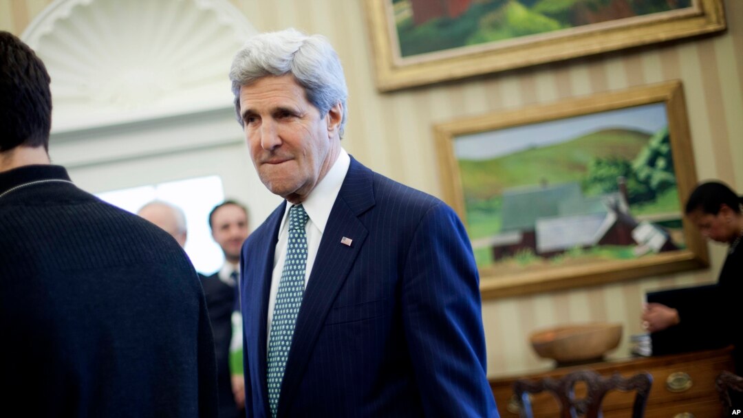 Secretary of State John Kerry is seen in the Oval Office of the White House in Washington, Monday, March 17, 2014, during President Barack Obama's meeting with Palestinian President Mahmoud Abbas.