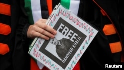 A demonstrator holds a sign during a protest at the University of California Los Angeles (UCLA), following the arrest in New York by U.S. immigration agents of Palestinian student protester Mahmoud Khalil, in Los Angeles, California, March 11, 2025.