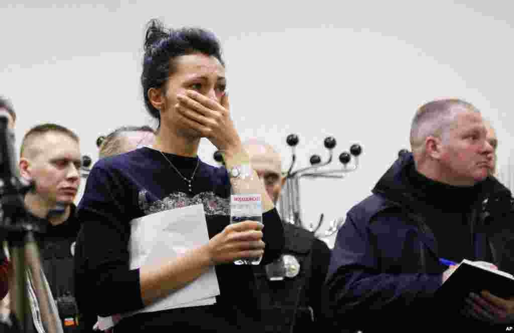 A Ukrainian International Airline company worker reacts during a briefing at Borispil international airport outside Kyiv. A Ukrainian airplane carrying 176 people crashed shortly after takeoff from Tehran's main airport, killing all onboard, Iranian state TV and officials in Ukraine said.