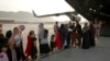 Afghans prepare to to be evacuated aboard a Qatari transport plane, at Hamid Karzai International Airport in Kabul, Afghanistan, August, 18, 2021. (Qatar Government Communications Office via AP)