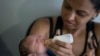 Daniele Ferreira dos Santos feeds her son Juan Pedro, who suffers from microcephaly, as they wait to be examined at the Altino Ventura Foundation, a treatment center that provides free health care, in Recife, Pernambuco state, Brazil, Feb. 4, 2016. 