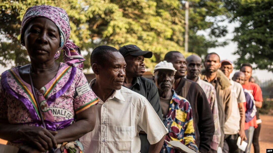 Voters line up outside a polling station in Bangui, to vote for a constitutional referendum, Dec. 13, 2015.