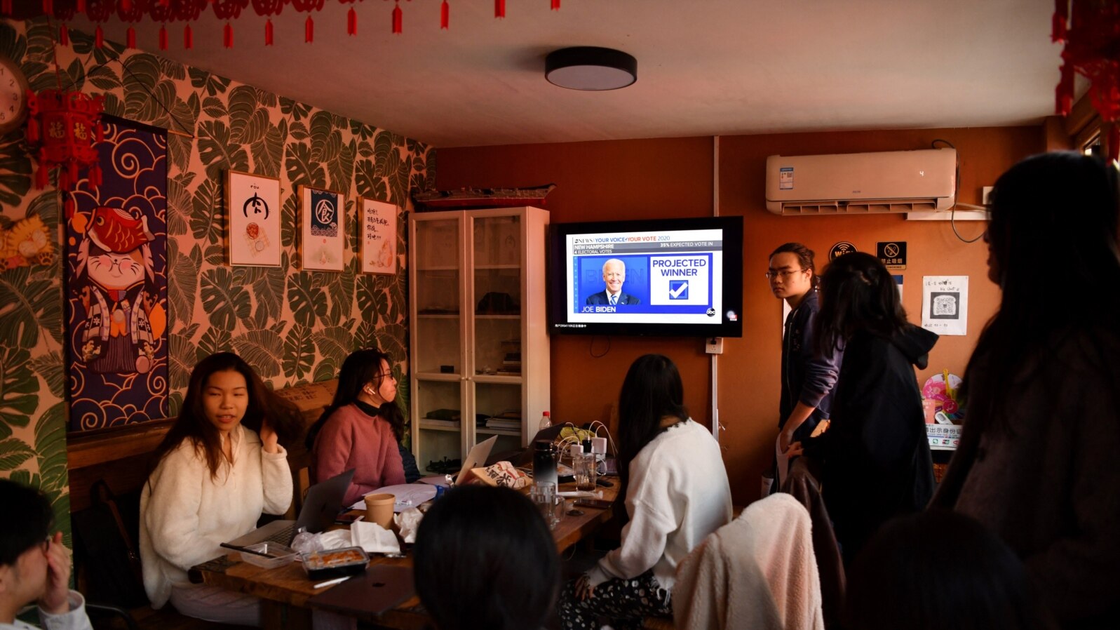 A group of Chinese students who study at U.S. universities watch online live coverage of the U.S. presidential election at an apartment in Beijing on Nov. 4, 2020.