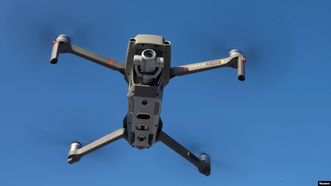 FILE - A drone is seen in the sky as Chinese drone maker DJI holds a demonstration to display an app that tracks a drone's registration and owner in Montreal, Canada, Nov. 13, 2019.
