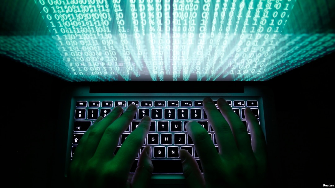 FILE - A man types on a computer keyboard.
