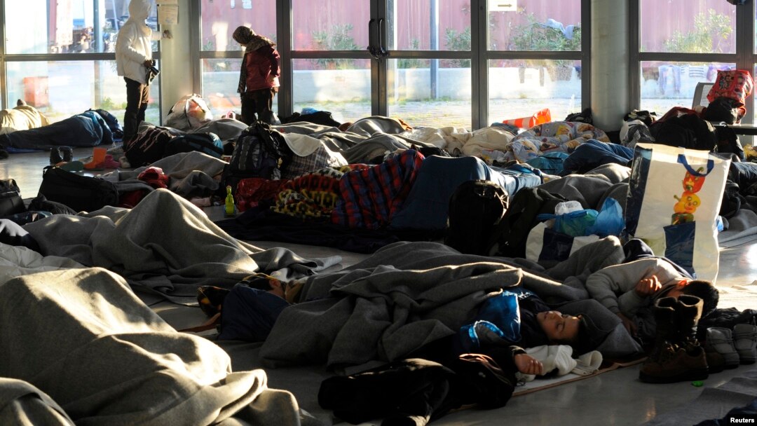 Refugees and migrants sleep inside a passenger terminal at the port of Piraeus, near Athens, Greece, Feb. 7, 2016. 