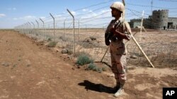 FILE - An Iranian border guard is seen on patrol near Taibad in eastern Iran, June 1, 2014. Iranian state media reported Wednesday that ten Iranian border guards were killed in a "terrorist attack" launched from inside Pakistan.