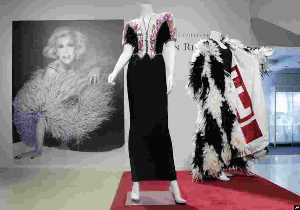 A beaded evening gown, center, owned by the late comedian Joan Rivers, is displayed at Christie's in New York. The Private Collection of Joan Rivers has more than 200 lots to be auctioned in a live sale on June 22 with about 80 more offered online the following day.