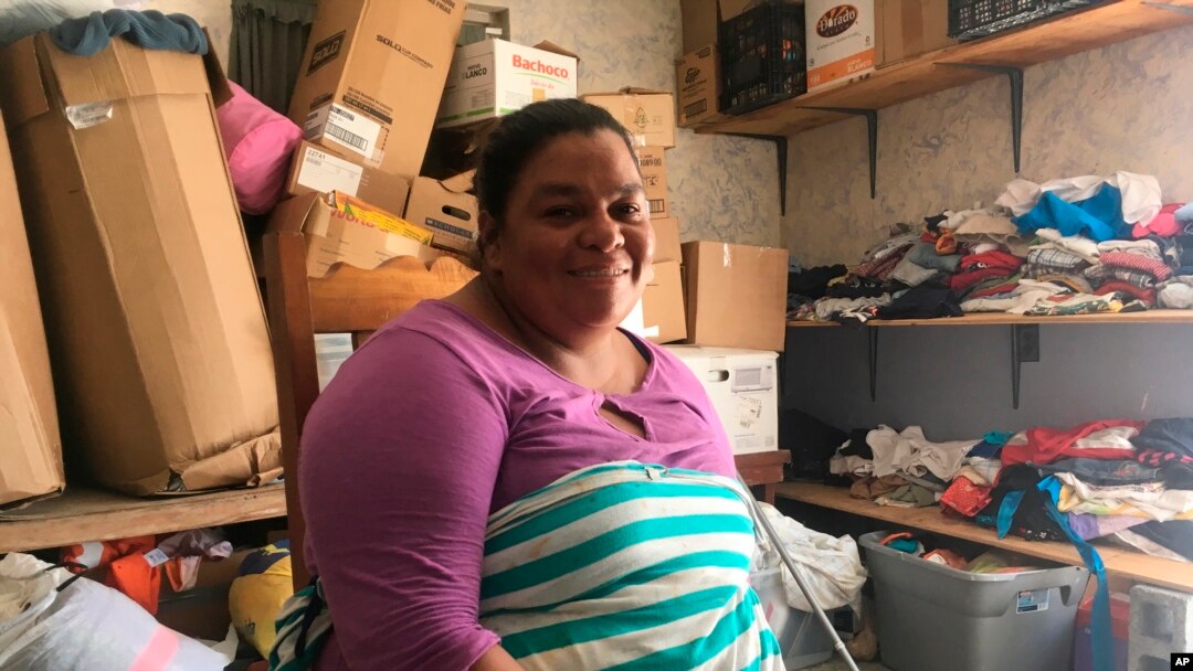 Piedad de Jesus Mejia sits in a storage room at the Senda de Vida migrant shelter in Reynosa, Mexico, June 30, 2018. Mejia and her husband, Isidro Sacasa, carried a hefty clear plastic folder from their home in Honduras with medical examiner's report and death records. Mejia said she and her husband and their children fled in April after receiving death threats and seeing two cousins slain in front of their home.