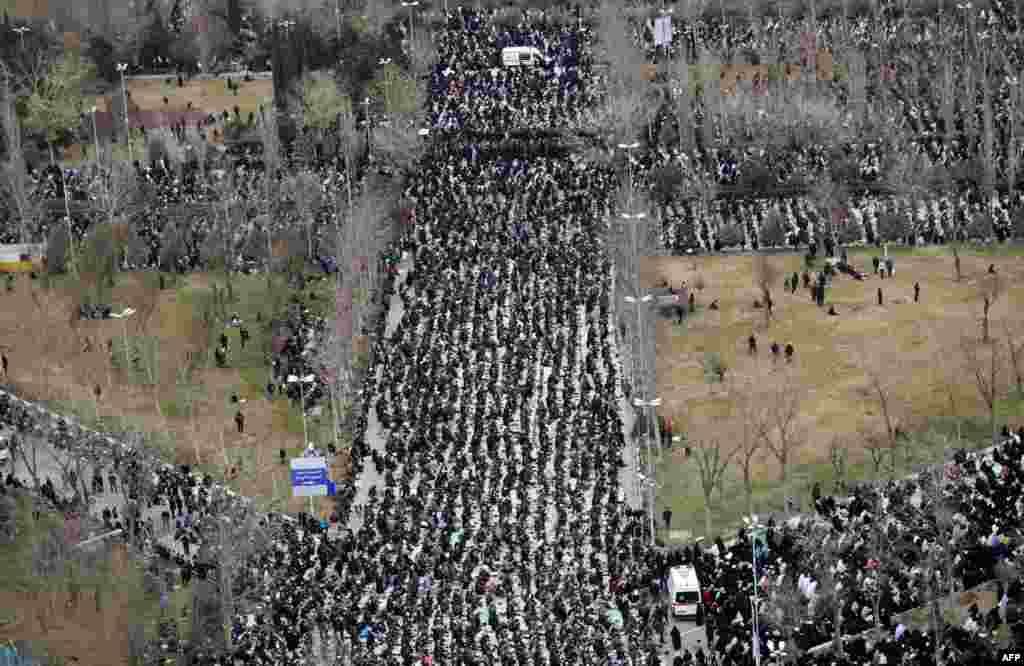 Crowds of worshippers follow as Iran's Supreme Leader Ayatollah Ali Khamenei leads Friday prayers during a ceremony at the capital Tehran's Grand Mosque, in this handout picture provided by the office of Khamenei.