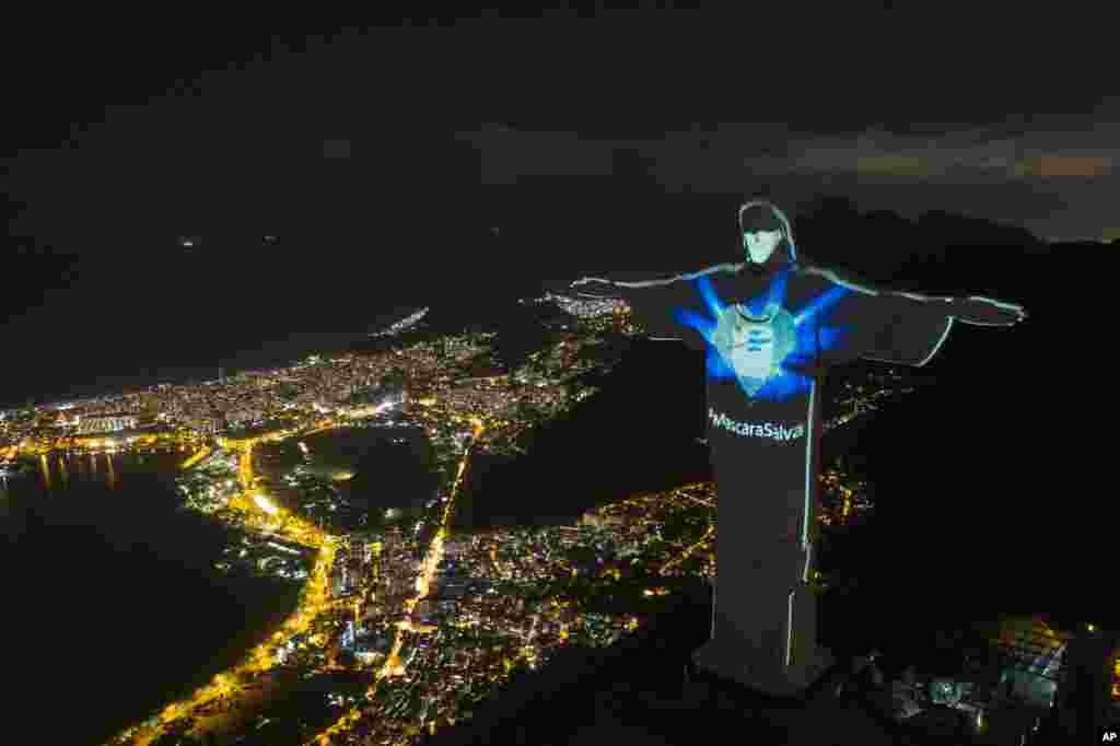 Rio's Christ the Redeemer statue is lit up as if wearing a protective mask in Rio de Janeiro, Brazil, May 3, 2020.