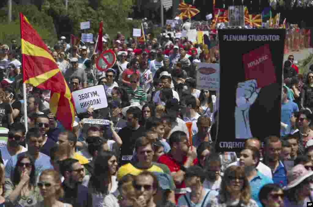 Protesters holding Macedonian flags and banners reading "Resignation" and "Goodbye Nikola" while they march towards the offices of Macedonia's conservative government in capital Skopje, May 17, 2015.