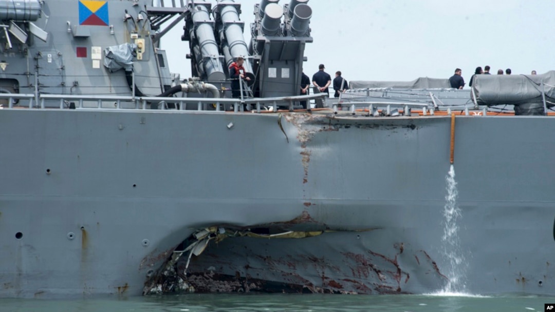FILE - damage is visible as the guided-missile destroyer USS John S. McCain steers towards Changi naval base in Singapore following a collision with the merchant vessel Alnic MC. 
