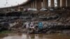 FILE - Women perform a traditional ceremony on the shore of the Niger river, next to the 'Third Bridge', in Bamak, Mali, July 2, 2021. 