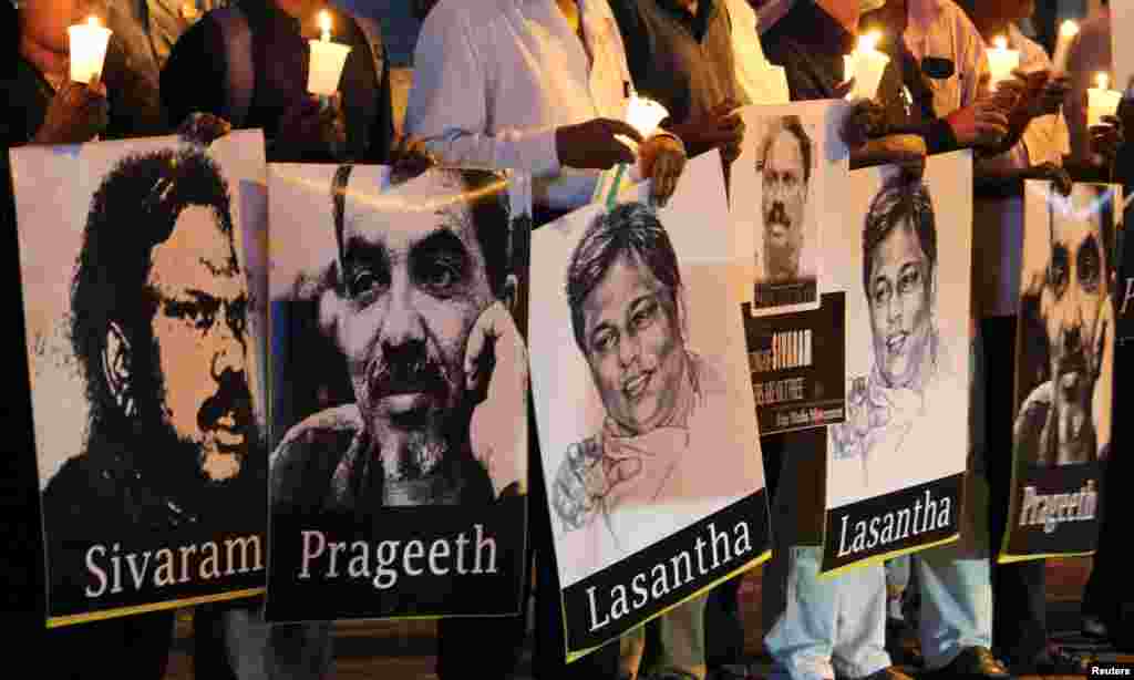 Media members of Sri Lanka hold placards of journalists at the "Black January" vigil to commemorate what organizers said are the killing and abductions of journalists who have disappeared during the month of January in the past years, in Colombia.