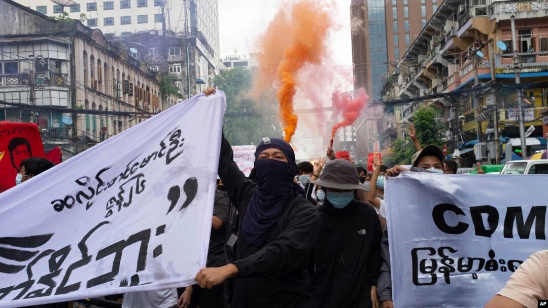 FILE - Anti-coup protesters shout slogans as they march during a protest in Pabedan township against the military junta, in Yangon, Myanmar, June 26, 2021.