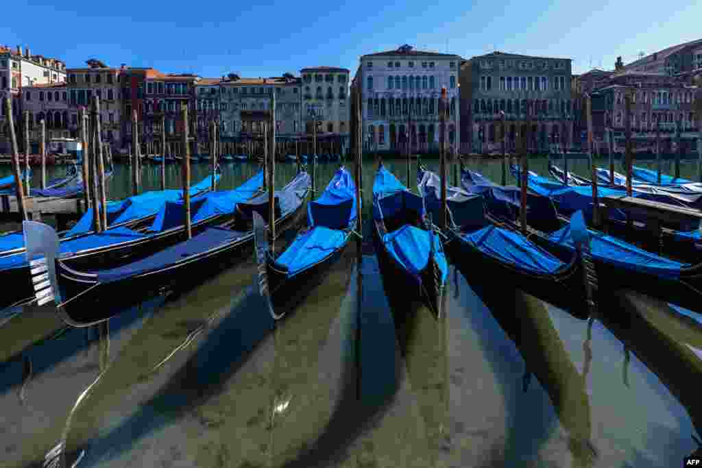 A view shows clear waters by gondolas in Venice's Grand Canal, March 18, 2020, as a result of the stoppage of motorboat traffic, following the country's lockdown due to the coronavirus crisis.