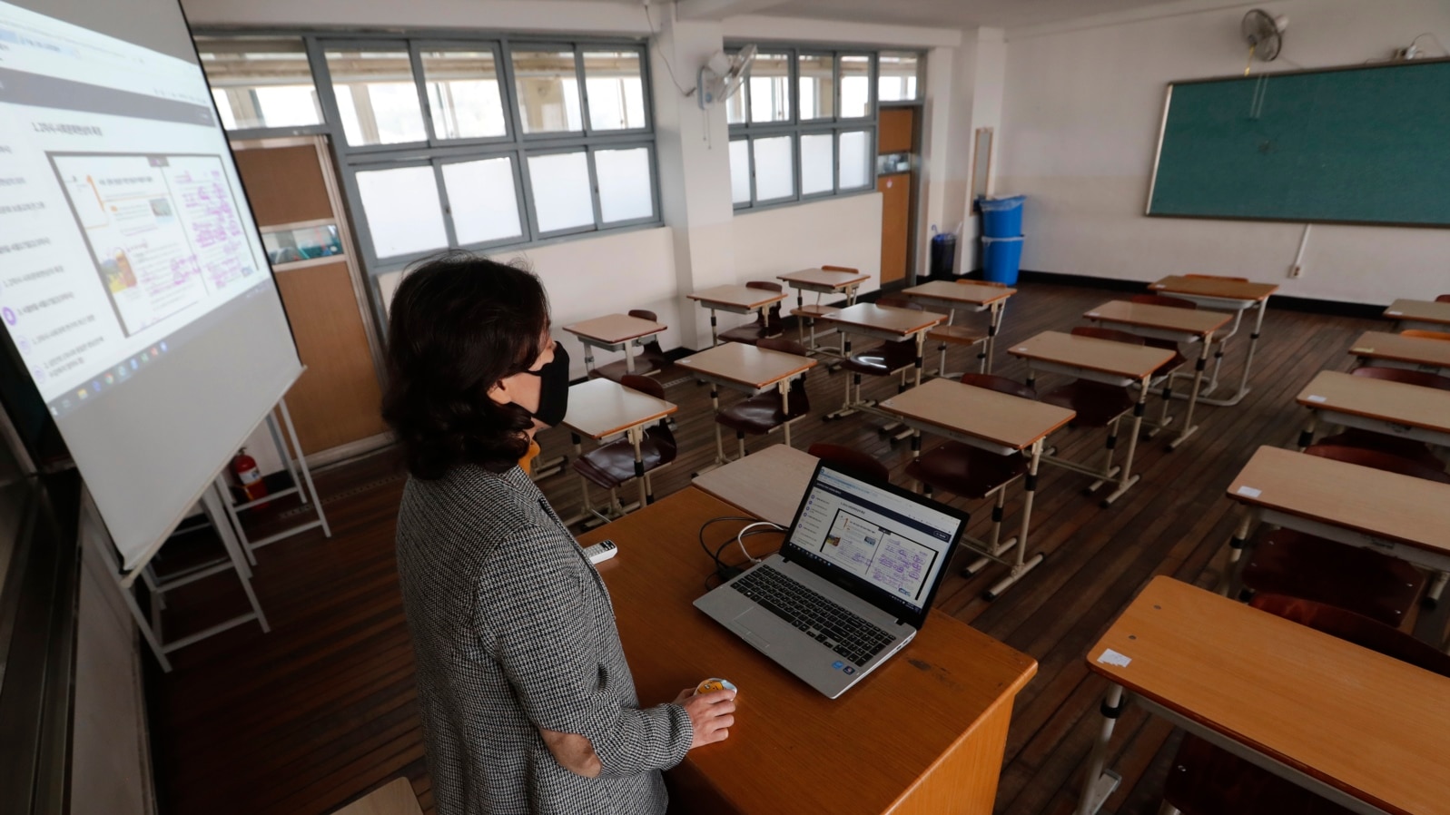 An unidentified teacher gives an online class amid the new coronavirus outbreak at Seoul girls' high school in Seoul, Thursday, April 9, 2020.