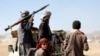 Houthi fighters and tribesmen stage a rally against the U.S. and the U.K. strikes on Houthi-run military sites near Sanaa, Yemen, Jan. 14, 2024. 