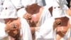 Christian penitents known locally as "Battenti" beas themselves during a procession in honor of the Virgin Mary in Guardia Sanframondi, on August 22, 2010.