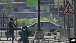 Police officers detain a protester at the Lekki toll gate in Lagos, Nigeria, Oct. 21, 2020.