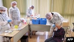 Một phụ nữ tiêm vaccine ở Tokyo ngày 12/04/2021.
